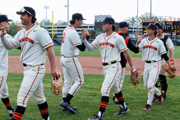 A group of baseball players are walking on the field.