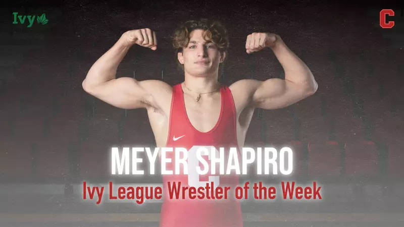 A young man in red wrestling outfit with text.